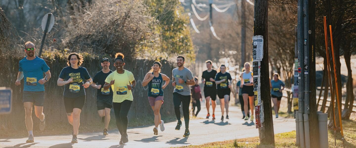 Residents running together through a neighborhood during a community race